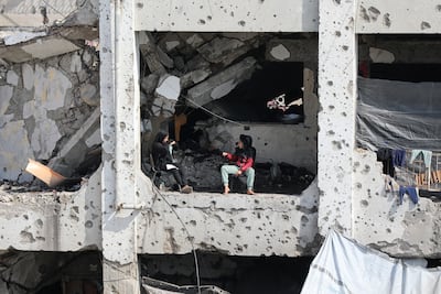 Palestinians in the rubble of destroyed buildings in Gaza city. Reuters