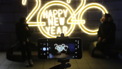 People pose for photos to celebrate upcoming New Year in Seoul, South Korea. AP Photo