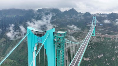 The Huajiang Grand Canyon Bridge, the world's highest, towers into the clouds in China's south-west Guizhou province. AFP