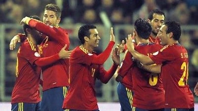 Spain players celebrate their 4-0 victory over Belarus on Friday. The world and European champions will be looking to extend their winning start in Group I against France tonight. Tatyana Zenkovich / EPA
