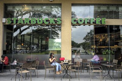 Customers hang out at a Starbucks coffee shop at Parksons Mall in Kuching, Sarawak, Malaysia. Sarawak is separated from peninsular Malaysia by the South China Sea. American businesses flourish in the region. Bloomberg