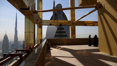 A visitor takes photos at the 71st floor of the Gevora Hotel, the world's tallest hotel, in Dubai. Reuters