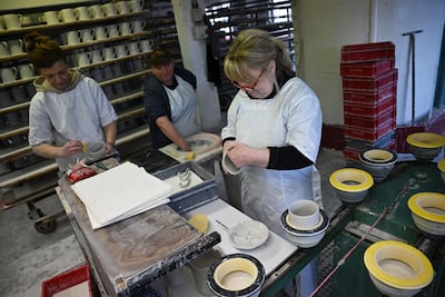 Pottery workers at the manufacturing unit, which is kept under wraps. AFP