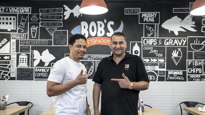 Alvin Flynn, left, has bounced back from a job loss after wowing Vinay Khosla, right, owner of Bob's Fish and Chips, with his Caribbean cooking skills. Antonie Robertson / The National