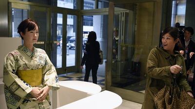 A woman reacts in surprise as she looks at Toshiba’s humanoid robot. FRANCK ROBICHON / EPA