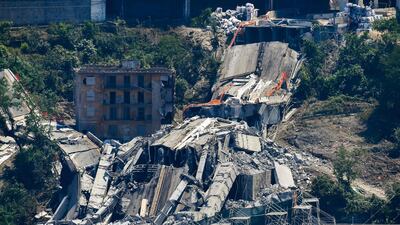 The bridge's deck debris and rubble among evacuated buildings after explosive charges blew up the eastern pylons of Genoa's Morandi motorway bridge in Genoa. AFP