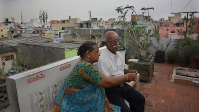 Retired Indian civil servant R. Devarajan with his wife Padmini sit at the terrace of their house equipped with rain water harvesting system in Chennai, India. AP