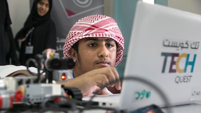 Abdullah Ali Ameri, 14, programs a robot at the Higher Colleges of Technology Men's College in Abu Dhabi designed to encourage more youngsters into a career in the sciences. Silvia Razgova / The National
