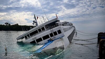 A ferry lists on its side at the Padangbai ferry port in Karangasem on Bali island, Indonesia. AFP