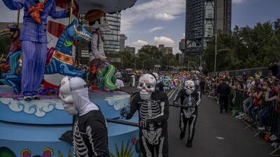 Participants dressed in costume during the Day of The Dead parade in Mexico City. Bloomberg