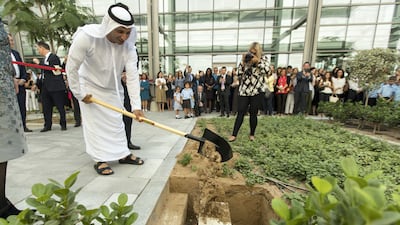 Dr Abdulla Al Karam, director general of the KHDA, helps bury a time capsule at North London Collegiate School to mark its official opening. Christopher Pike / The National