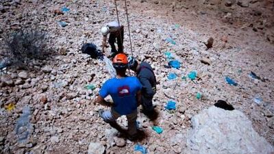 Members of the Middle East Caving Expeditionary Team clean up the floor of the Majlis Al Jinn, 150 metres underneath Oman's Selma Plateau.