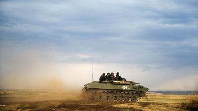 A Russian APC moves in a field in about 10 kilometers from the Russia-Ukrainian border control point at Russian town of Donetsk, Rostov-on-Don region. Pavel Golovkin / AP Photo
