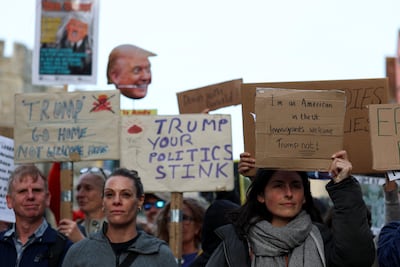 Demonstrators hold signs and placards during a 'Trump Not Welcome' protest in Windsor. Reuters