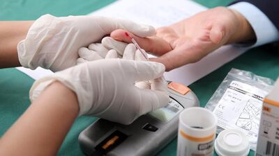 A man has his blood glucose screening tested as part of the World Health Day 2016. Luong Tha Linh / EPA