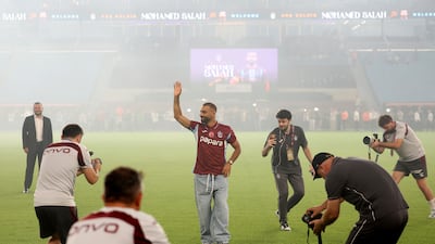 Salah waves from the pitch. Reuters