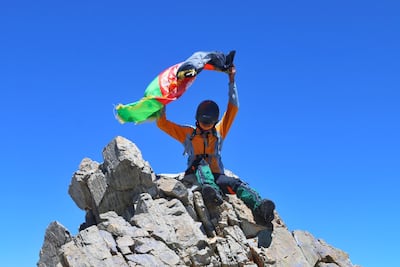 Zabih Afzali holding the Afghanistan flag having submitted Mount Shah Fuladi in June 2020. Courtesy Zabih Afzali