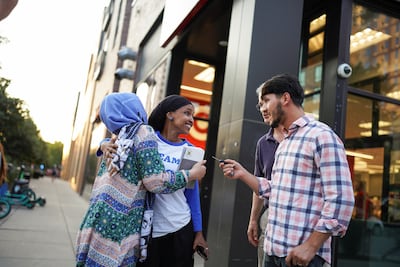 Ms Omar greets supporters outside a Target store during primary election day in Minneapolis. Reuters