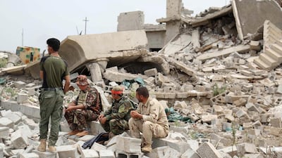 Iraqi Kurdish and Turkmen Shiite forces sit in the northern Iraqi town of Bashir after they recaptured the town from ISIS on May 1, 2016. AFP