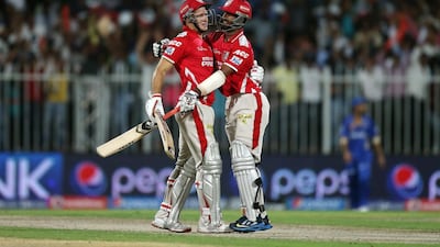 David Miller, left, and Cheteshwar Pujara of Kings XI Punjab celebrating after winning the IPL match against Rajasthan Royals at Sharjah Cricket Stadium. Pawan Singh / The National / April 20, 2014