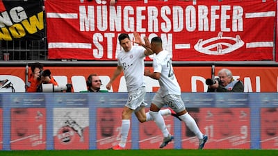 Robert Lewandowski, left, celebrates the opening goal. AFP