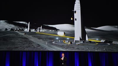 Billionaire entrepreneur and founder of SpaceX Elon Musk speaks below a computer generated illustration of his new rocket at the 68th International Astronautical Congress 2017 in Adelaide on September 29, 2017. Peter Parks / AFP