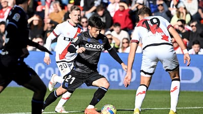 Real Sociedad's Spanish midfielder David Silva (C) fights for the ball with Rayo Vallecano's Albanian defender Ivan Balliu (L) and Rayo Vallecano's French defender Florian Lejeune during the Spanish league football match between Rayo Vallecano de Madrid and Real Sociedad at the Vallecas stadium in Madrid on January 21, 2023. (Photo by OSCAR DEL POZO / AFP)