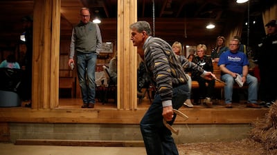 Senator Joe Manchin throws a horse shoe as supporters watc at Hound Dog Adkins Barn in Peach Creek, West Virginia. Reuters