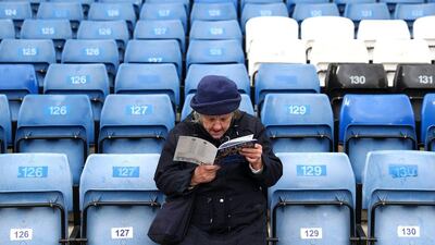 A Chelsea supporter reads the matchday programme prior to the Premier League match between Chelsea and West Ham United at Stamford Bridge on March 19, 2016 in London, United Kingdom. (Photo by Paul Gilham/Getty Images)