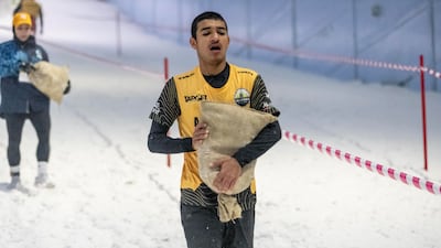 Competitors carried sand bags through the snow.