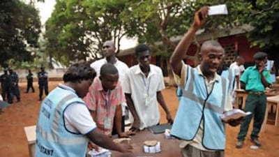 Electoral officers count the ballots at an Accra polling station after the presidential elections.