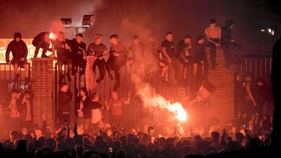 Liverpool fans celebrate outside Anfield stadium as Liverpool lift the Premier League trophy on July 22 in Liverpool. Getty Images