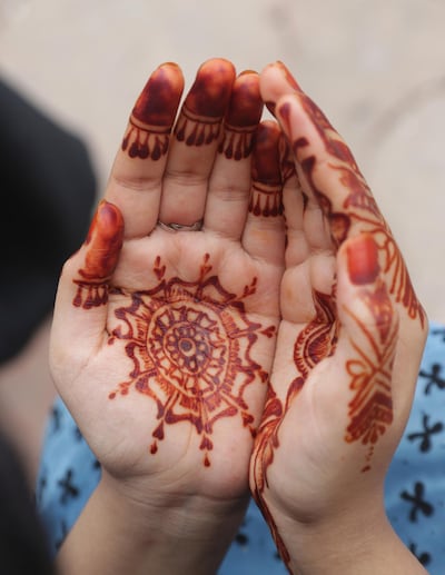 A Pakistani girl prays during the Eid al-Adha holiday. KM Chaudary / AP