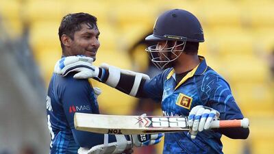 Kumar Sangakkara, left, and Lahiru Thirimanne, right, congratulate each other after guiding Sri Lanka to a nine wicket win over England. Both batsmen hit unbeaten centuries on the way to victory. William West / AFP