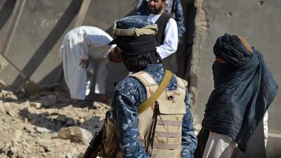 Taliban members stand guard in front of the rubble of a suspected ISIS hideout, during an operation against ISIS-Khorasan. Photo: AFP