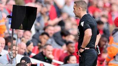 Referee Craig Pawson checks the Video Assistant Referee. Getty