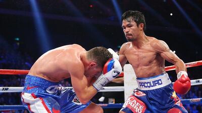 MACAU - NOVEMBER 23: Manny Pacquiao of the Philippines punches Chris Algieri of the United States during the WBO world welterweight title at The Venetian on November 23, 2014 in Macau, Macau. (Photo by Chris Hyde/Getty Images)