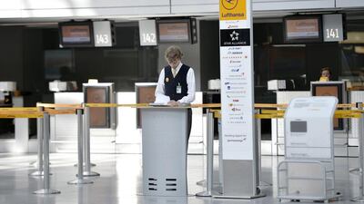 A Lufthansa employee stands in front of empty counters at the airport in Duesseldorf. It is unlikely Lufthansa’s flight schedules will return to normal even after the pilots return to work. Martin Meissner / AP Photo