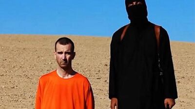A frame grab from a video released by the ISIL on September 14, 2014 showed a militant holding a knife before purportedly executing British aid worker David Cawthorne Haines, left. Haines was kidnapped in March 2013 in Syria. EPA