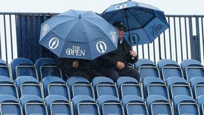 Spectators shelter from the rain under umbrellas during the second round on day two of the 145th Open Championship at Royal Troon on July 15, 2016 in Troon, Scotland. (Photo by Andrew Redington/Getty Images)