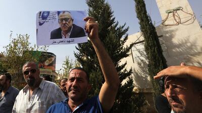 A man holds up a photo of Nahed Hattar, who was shot dead earlier in the day, in his family's hometown of Fuheis on September 25 2016. Hattar. Jamal Nasrallah/EPA