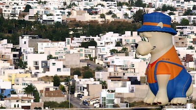A hot air balloon in the shape of a dog flies over Leon, Mexico. AFP
