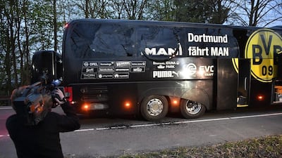 A camera man films Borussia Dortmund's team bus after it was damaged in an explosion before the Uefa Champions League quarter-final match between Borussia Dortmund and AS Monaco in Dortmund, western Germany, Tuesday, April 11, 2017. Martin Meissner / AP Photo