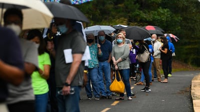 Voters wait in a line to vote that has an estimated 3-hour as the first day of early voting is underway at the George Pierce Park in Suwanee, Georgia, USA. EPA