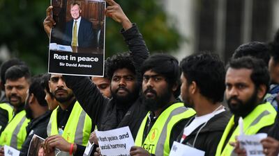 People from the Tamil community hold a vigil for MP Sir David Amess outside parliament in London, Britain, 18 October 2021. British Prime Minister Johnson is to lead tributes to MP David Amess at parliament later today. Amess was stabbed to death at a church in Leigh-on-Sea on 15 October. EPA / ANDY RAIN
