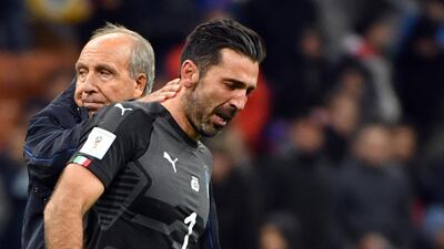 Italy coach Gian Piero Ventura, left, consoles Gianluigi Buffon after they missed out on qualification for World Cup 2018. Daniel Dal Zennaro / ANSA via AP