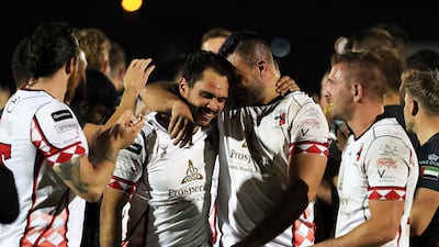 Abu Dhabi Harlequins players celebrate after winning the UAE Premiership final against Dubai Exiles at The Sevens rugby stadium in Dubai. All photos Pawan Singh / The National