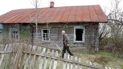 A displaced villager visits his childhood home in an abandoned hamlet near the exclusion zone around Chernobyl on Monday for Radunista - a holiday in the Eastern Orthodox Church. Every year residents, who left after the Chernobyl blast, gather at the cemeteries to visit the graves of relatives and to meet former friends.