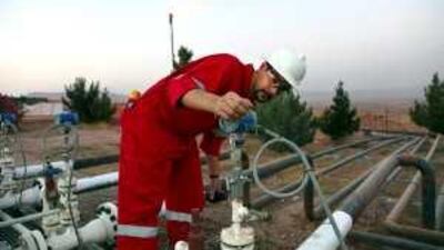 A worker adjusts a valve of an oil pipe at Taq Taq oil field in Arbil, 310 km north of Baghdad.