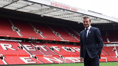 David Beckham poses on the pitch at Old Trafford ahead of a charity football match in aid of Unicef Beckham will lead the Great Britain team against a Rest of the World team led by Zinedine Zidane at Old Trafford on November 14. Paul Ellis / AFP